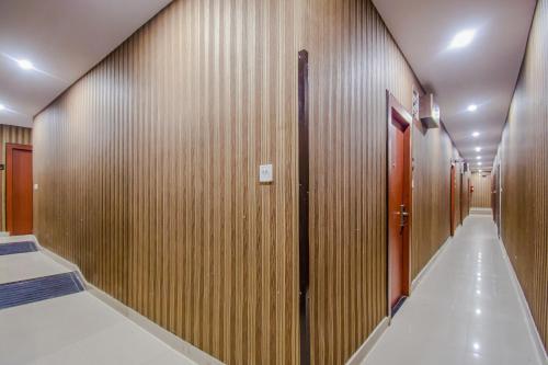 a hallway with wooden walls and a corridorngthngthngthngth at Collection O MG Guest House in Kolkata