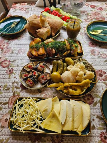 a table with many plates of food on it at Vardzia Old Village in Vardzia