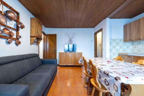 a living room with a table and a couch at Cesa Alpes 2 in Campitello di Fassa