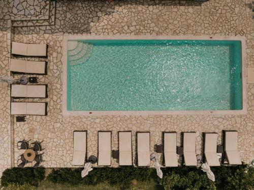 an overhead view of a pool with chairs and water at Villa Apollo in Parga