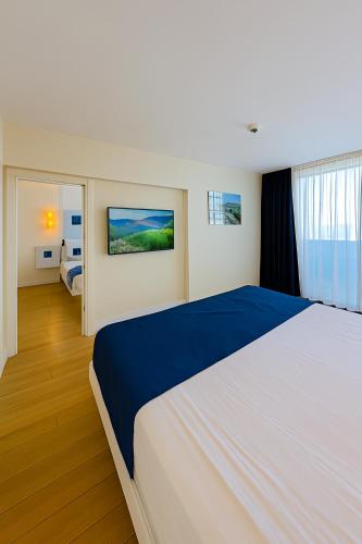 a bedroom with a large white bed in a room at Orbi City - Sea View Aparthotel in Batumi in Batumi