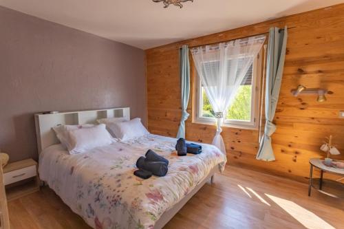 a bedroom with a bed with two stuffed animals on it at Au petit bonheur in Hautefage-la-Tour