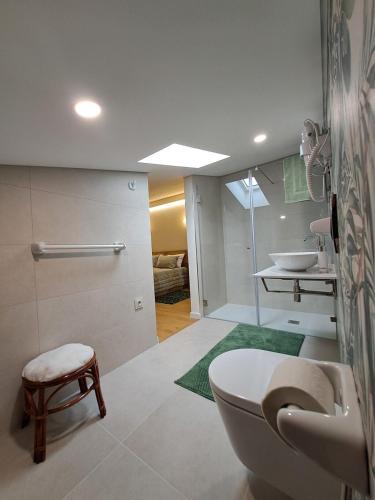 a bathroom with a toilet and a sink at Casa da Tapada in São João da Pesqueira