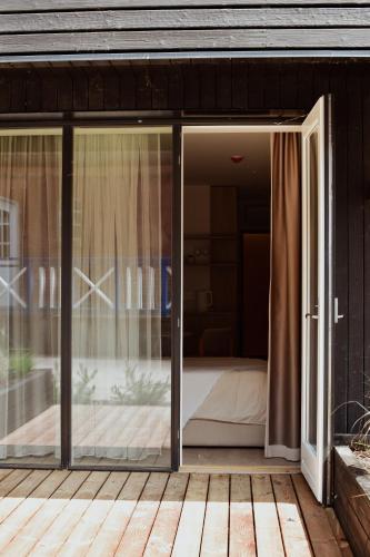 an open sliding glass door on a patio at Nidos Banga in Nida