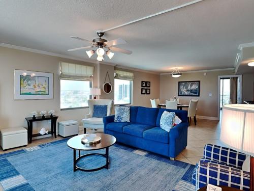 a living room with a blue couch and a table at Perdido Towers #604 in Perdido Key