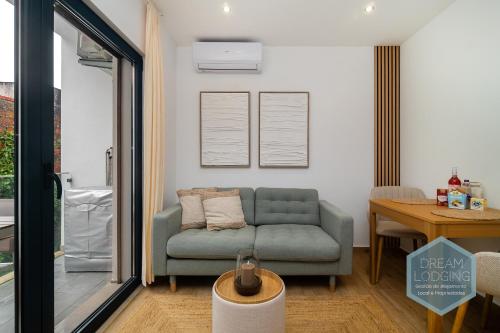 a living room with a couch and a table at Lagar da Vila - Dream Lodging in Avelar