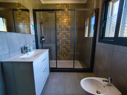 a bathroom with a shower and a sink and a toilet at Casa rural Chapinheira in Chapinheira