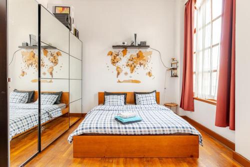 a bedroom with two beds and a map on the wall at Luxury home at Grand Place & Manneken Pis in Brussels