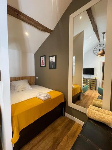 - une chambre avec un lit jaune et un miroir dans l'établissement Cap sur la mer - casa Paoli, à Brando