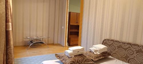 a hotel room with a couch and a table at Old Town apartment in Narva