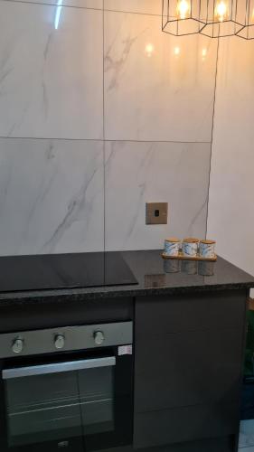 cocina con encimera negra y fogones en NO LOADSHEDDING 1 Bedroom Apartment, en Trichardt