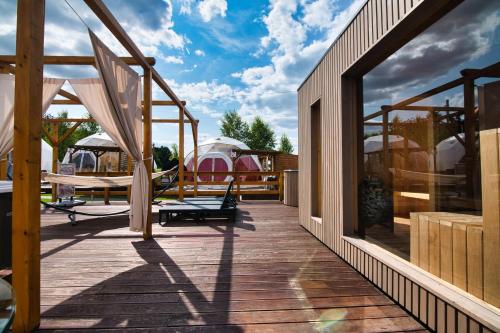 a wooden deck with a view of a house at Holiday Park Zator in Zator