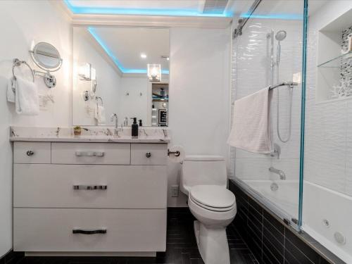 a bathroom with a toilet and a shower and a sink at Casa Feliz- Private Beachfront Oasis, Heated Pool, Movie Room & More! in Marathon