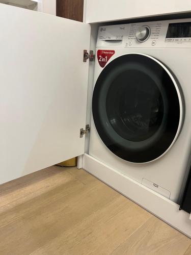 a white washing machine sitting in a room at Nemuno Banga in Druskininkai