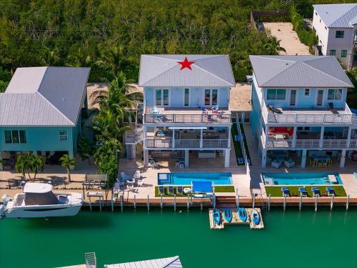 an aerial view of a house with a boat in the water at Casa Playa- Luxury Pool Home, 36' Dock in Marathon