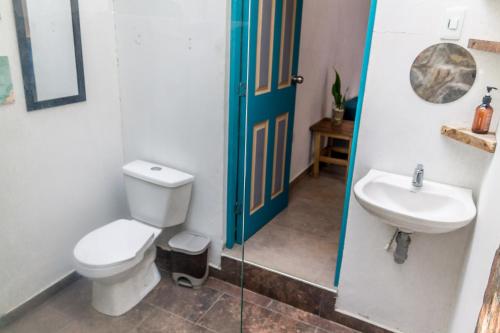 a bathroom with a toilet and a sink at AFRA Reserva Natural in Santa Marta