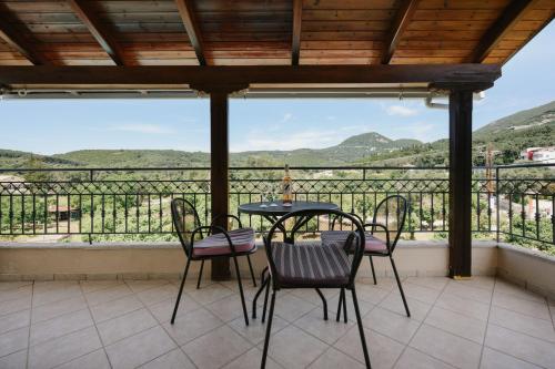 a table and chairs on a balcony with a view at Villa Apollo in Parga