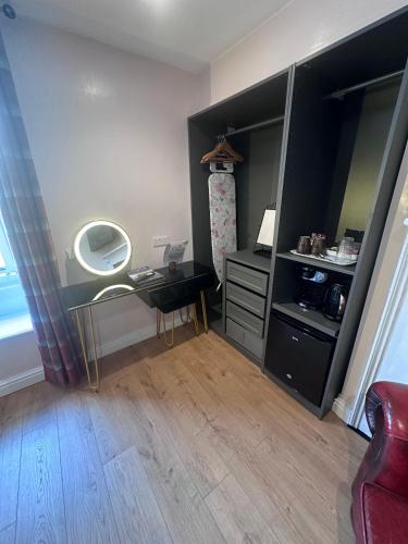 a room with a vanity and a mirror on a table at Laburnum Guest House at Bistro En Glaze in Wylam
