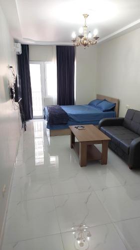 a living room with a couch and a coffee table at Bina 90 in Itʼkhvisi