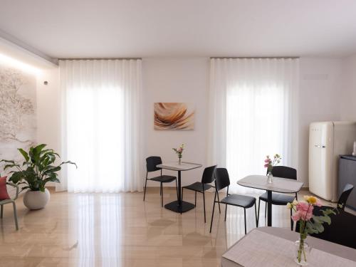 a dining room with two tables and chairs at Domus Eterea in Marsala