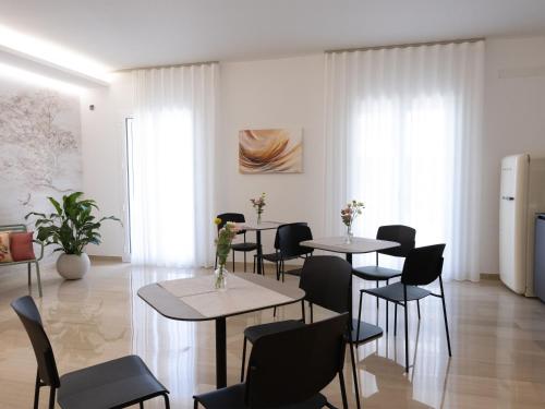 a dining room with two tables and chairs at Domus Eterea in Marsala