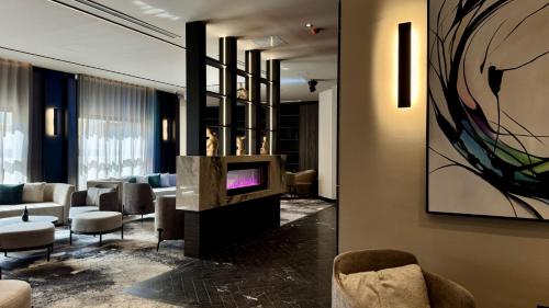 a lobby with couches and a tv in a room at ASTE hotel in St Julian's