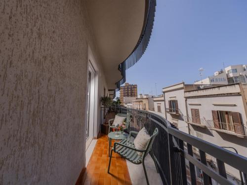 a balcony with two chairs and a view of a building at Domus Eterea in Marsala