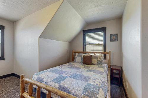 a bedroom with a bed in the corner of a room at Heider Cabin in Garden City