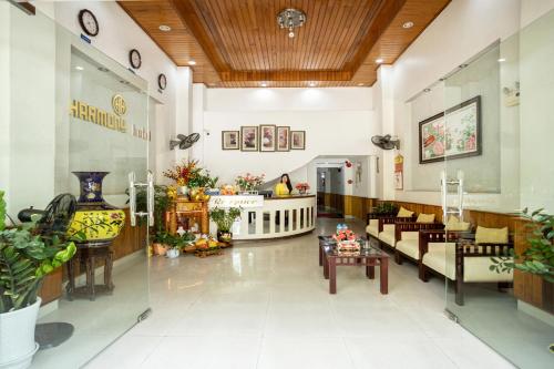 a lobby of a hospital with tables and chairs at Hue Harmony Hotel in Hue