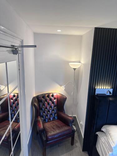 a leather chair in a room with a mirror at Laburnum Guest House at Bistro En Glaze in Wylam