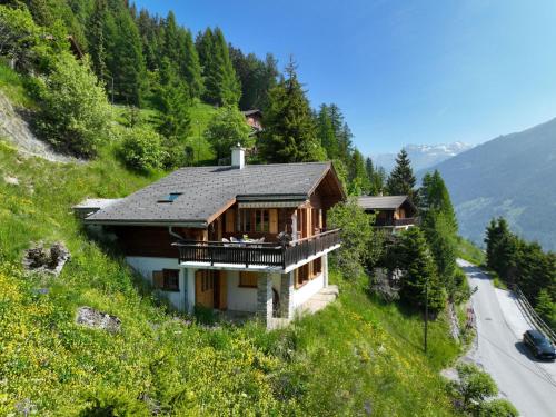 a house on the side of a hill with a road at Chalet Les Clarines by Interhome in Grimentz