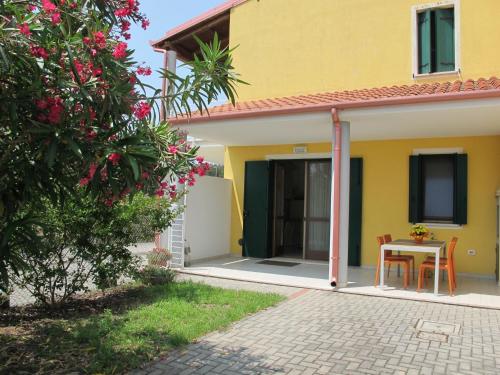 a yellow house with a table in front of it at Holiday Home Jolanda by Interhome in Bagni
