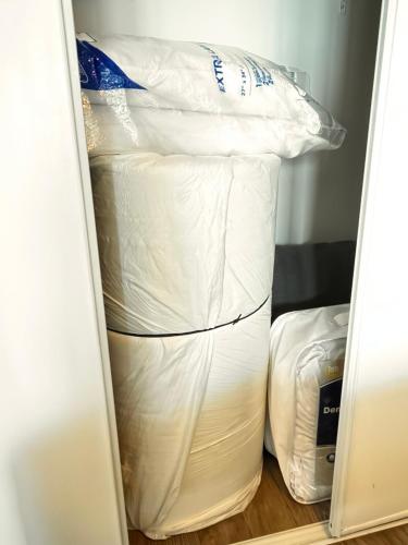 a closet filled with lots of white bags at CN lovers in Toronto