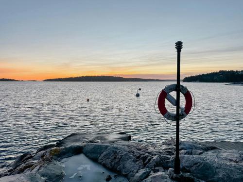 a sign on the shore of a body of water at Archipelago With Dock Close To The Sea in Nämdö