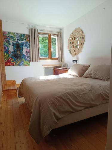 une chambre avec un grand lit et une fenêtre dans l'établissement Appartement au calme, à Saint-Gervais-les-Bains