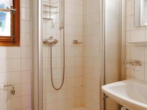 a bathroom with a shower and a sink at Chalet Coquelicot by Interhome in Zinal