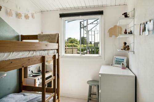 a small room with a bunk bed and a desk at Family Home On Enø Offers Idyllic Island Life in Karrebæksminde