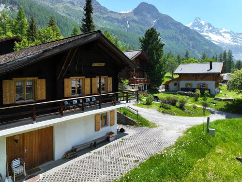 a building with mountains in the background at Chalet Coquelicot by Interhome in Zinal