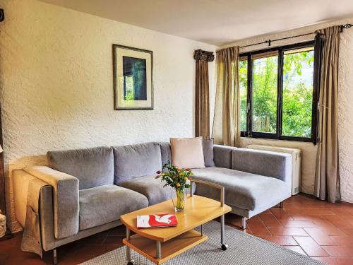 a living room with a couch and a table at Apartment Fiorita by Interhome in Brusino Arsizio