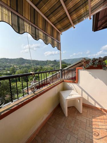 a balcony with a bench and a view at La Torretta in Beverino