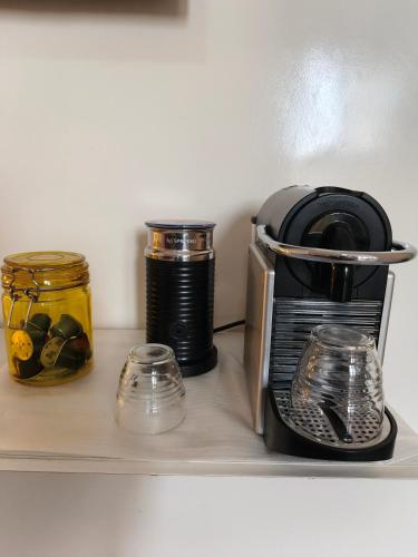 a coffee maker and jars on a shelf at bel studio de luxe a thies Sénégal in Thiès