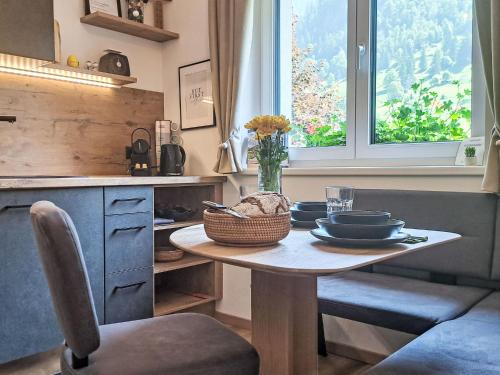a kitchen with a table with dishes on it at Apartment Apartement Haus Dankl by Interhome in Fusch an der Glocknerstraße