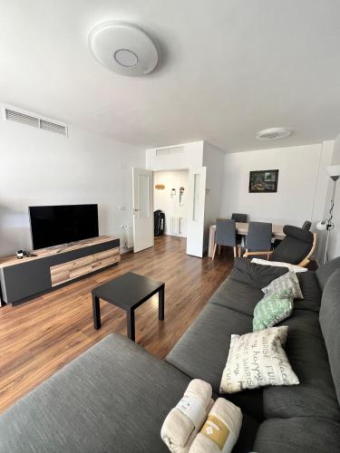 a living room with a couch and a flat screen tv at Apartment in campello Beach in El Campello