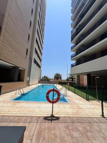 a swimming pool with a no swimming sign in front of a building at Apartment in campello Beach in El Campello