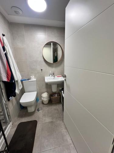 a bathroom with a toilet and a sink and a mirror at Apartment in campello Beach in El Campello