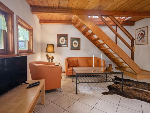 a living room with a couch and a tv at Holiday Home Sianowska Huta by Interhome in Pomieczyno