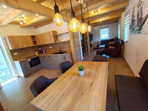 a living room with a wooden table and chairs at Chalet Pod lesem by Interhome in Smržovka
