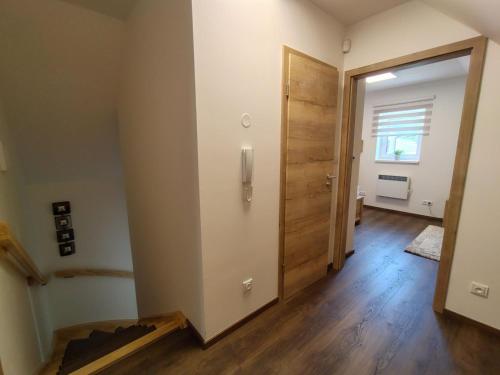 an empty room with a hallway with a wooden door at Chalet Pod lesem by Interhome in Smržovka