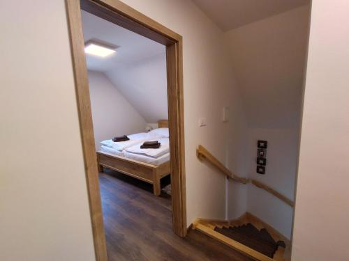 a bedroom with a bed and a mirror in a room at Chalet Pod lesem by Interhome in Smržovka