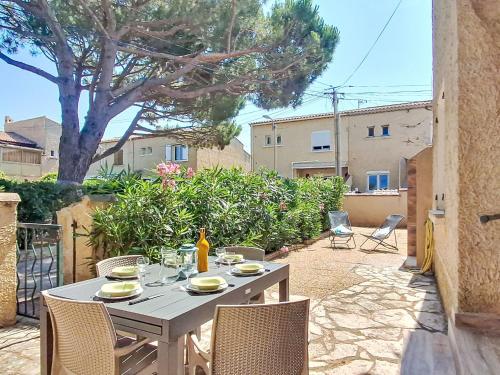a white table and chairs on a patio at Holiday Home Le Rayolet Parc by Interhome in Six-Fours-les-Plages